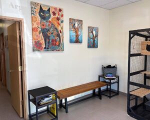 Lobby interior with paintings and a wooden bench