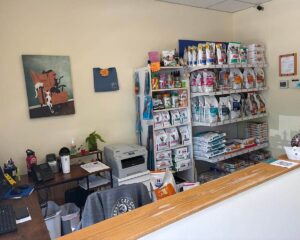 Front desk in lobby with shelves of cat food for sale